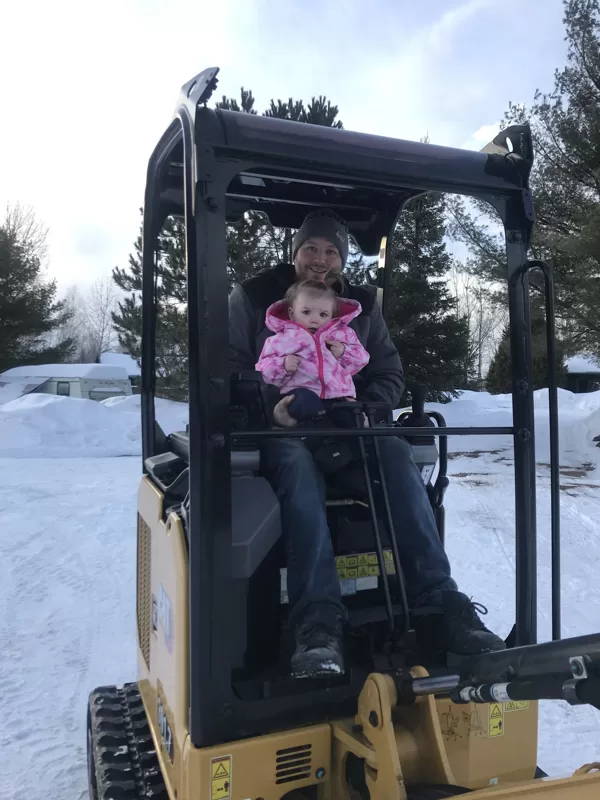 Randalls Equipment owner showing his daughter Annika her new toy